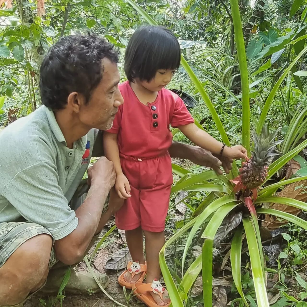 Natsir teaching a little girl
